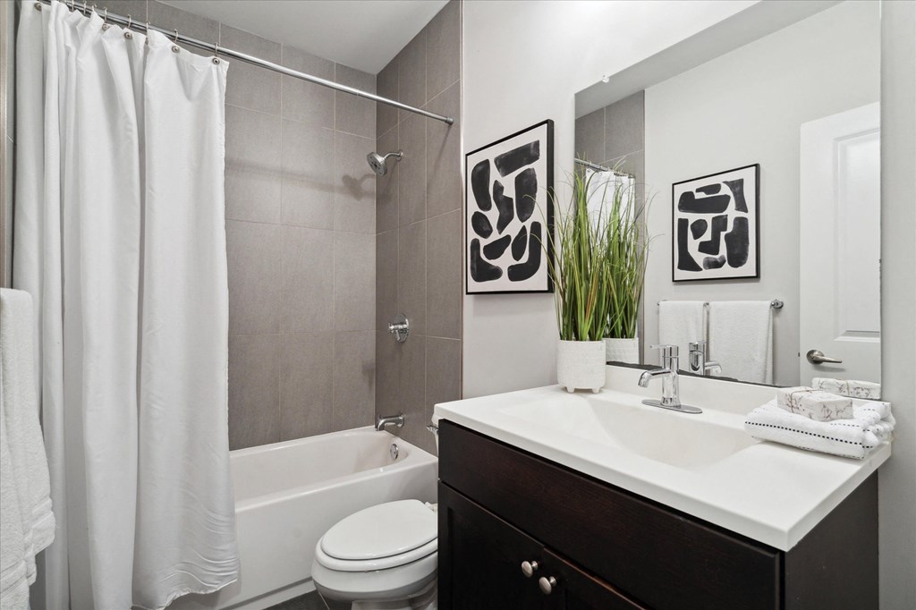 a bathroom with a sink and a shower and a toilet