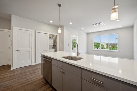 an empty kitchen with a sink and a window