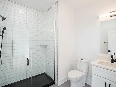 A white toilet sits next to a sink in a bathroom.