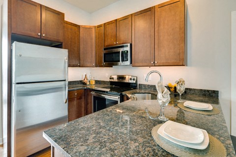 a kitchen with stainless steel appliances and granite counter tops