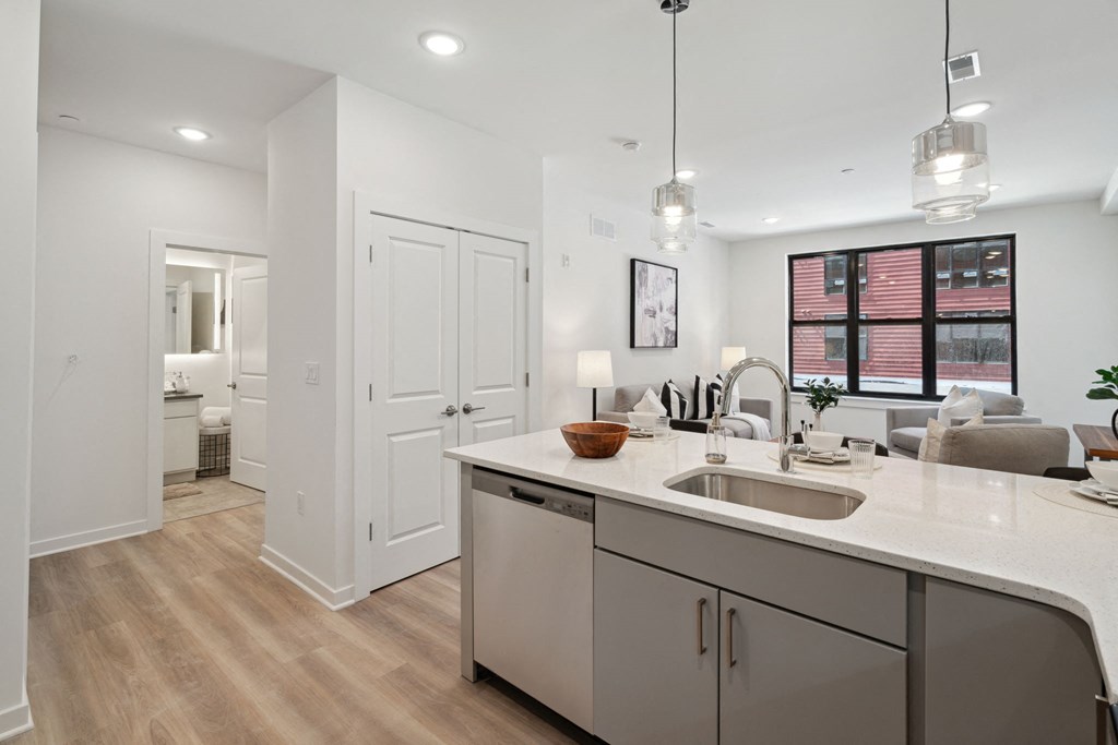 Kitchen and living room with white walls and a wooden floor  at The Anchorage on Kelly, Pennsylvania