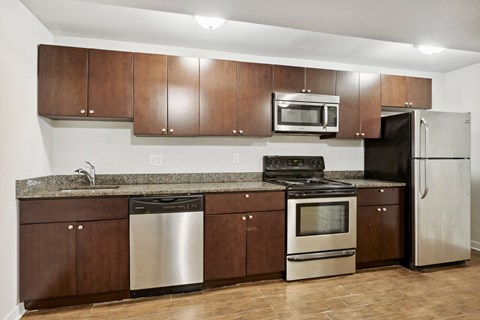 a kitchen with stainless steel appliances and wooden cabinets