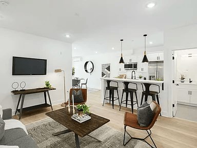 A modern living room with a wooden coffee table and a grey sofa.