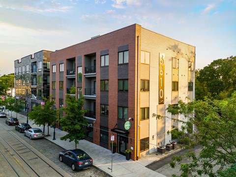 A street view of a row of modern apartment buildings.