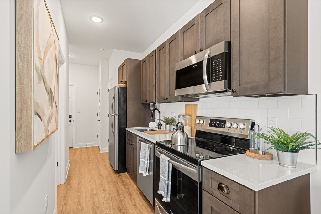 a kitchen with stainless steel appliances and wooden cabinets