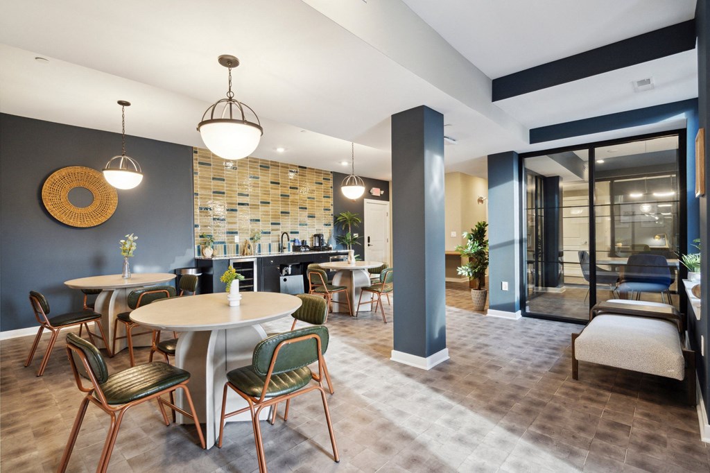 Communal area with tables and chairs and a kitchen in the background  at The Anchorage on Kelly, Philadelphia, PA, 19129