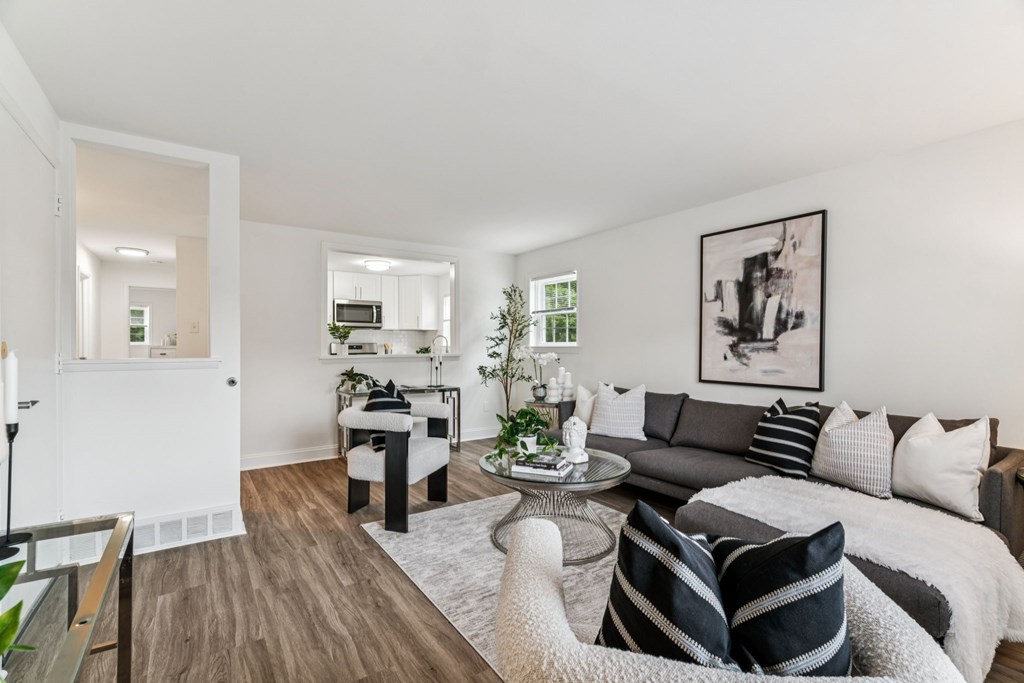 A modern living room with a grey couch and a coffee table.