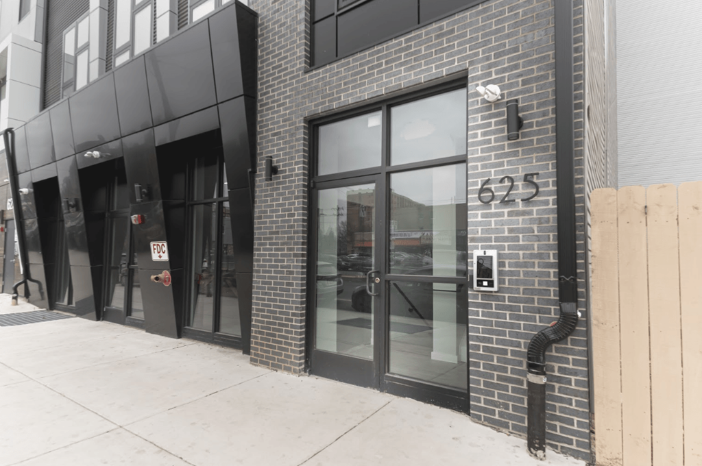 a brick building with black doors and windows