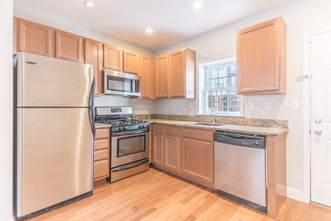 a kitchen with stainless steel appliances and wooden cabinets