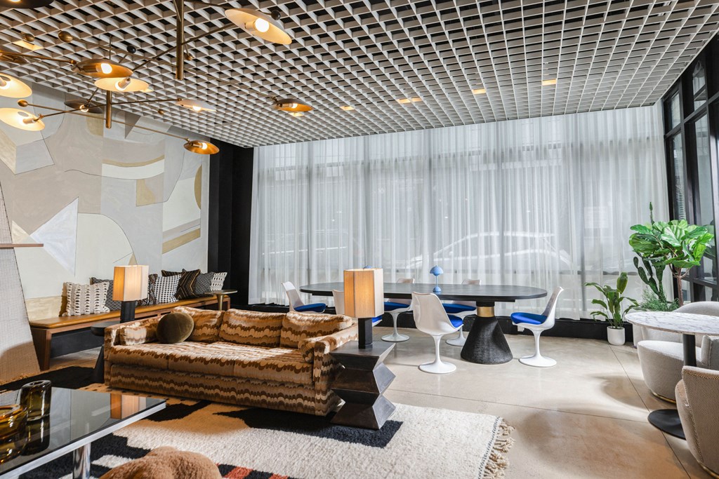 a living room with couches and chairs and a large window