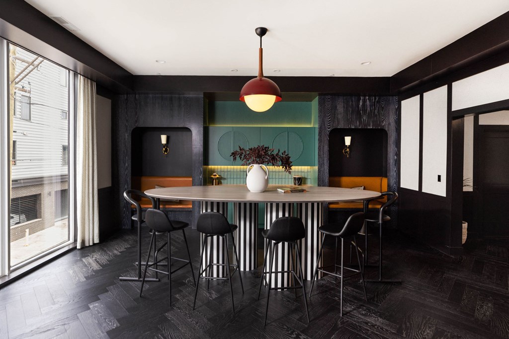 a dining room with a round table and chairs