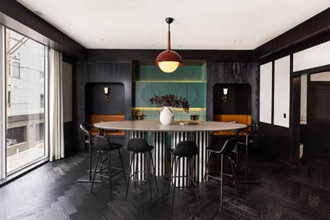 a dining room with a round table and chairs