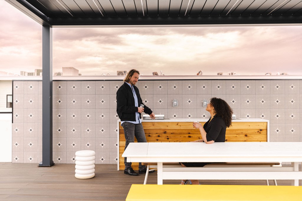 a man and a woman sitting at a table in a room