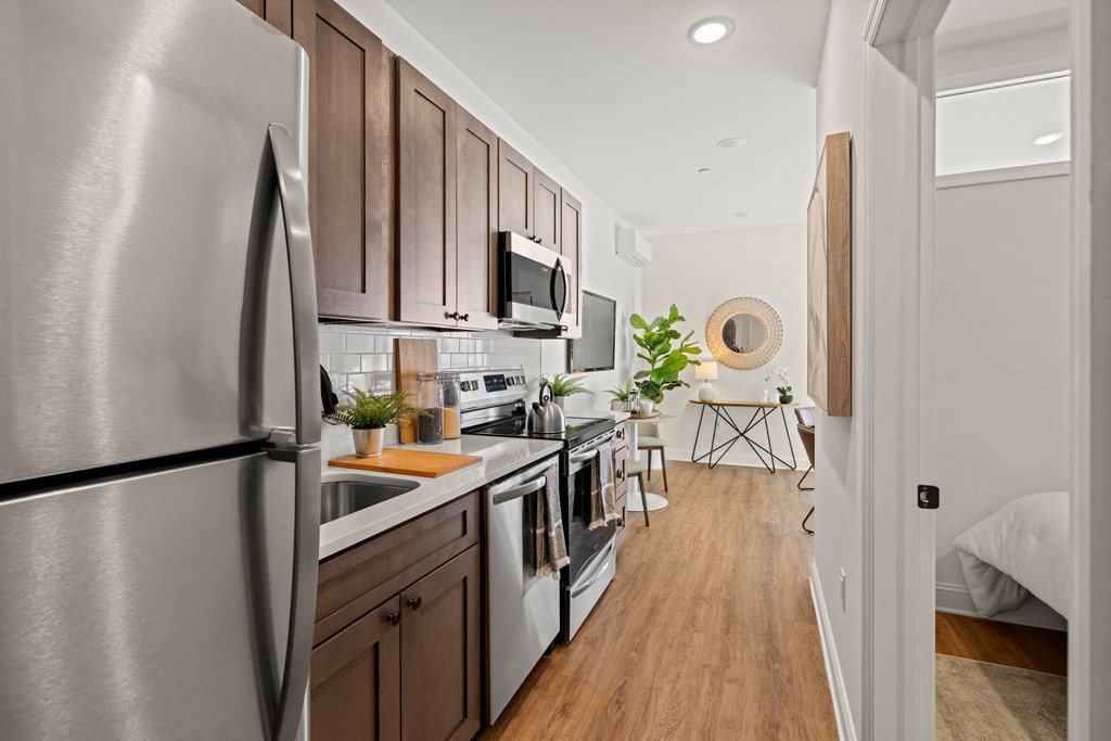 a kitchen with stainless steel appliances and wooden cabinets