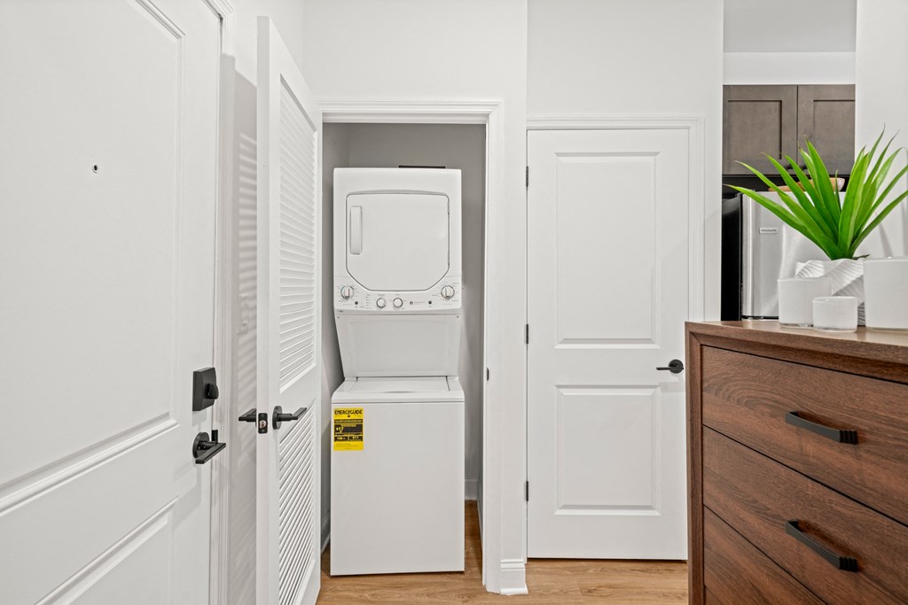 a white washer and dryer in a small laundry room