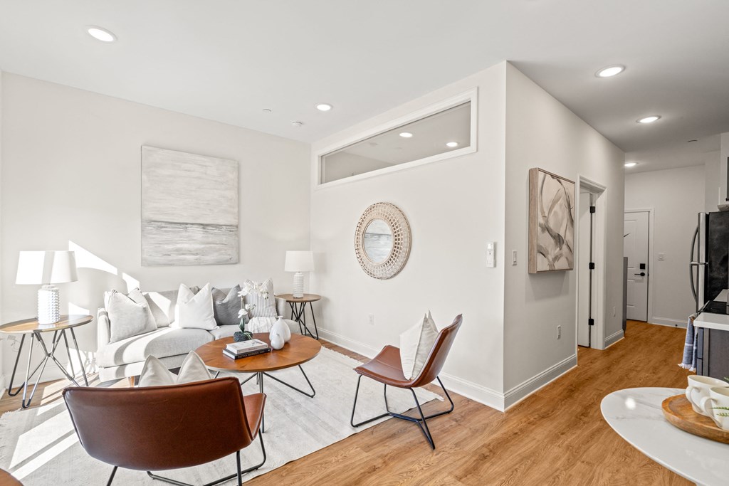 a living room with a couch and a table and chairs