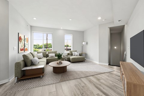 A modern living room with a green couch and a coffee table.