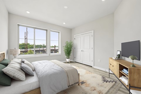A bedroom with a large bed and a flat screen TV.