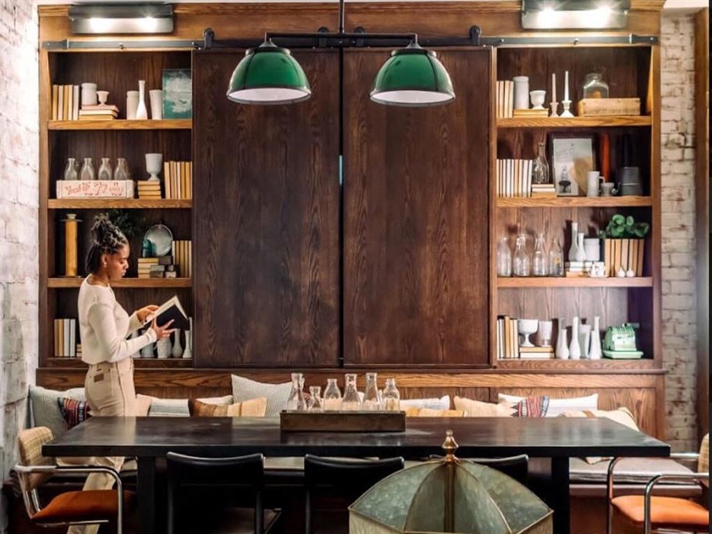 a woman standing next to a table in a restaurant