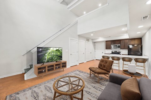 A living room with a television and a staircase.