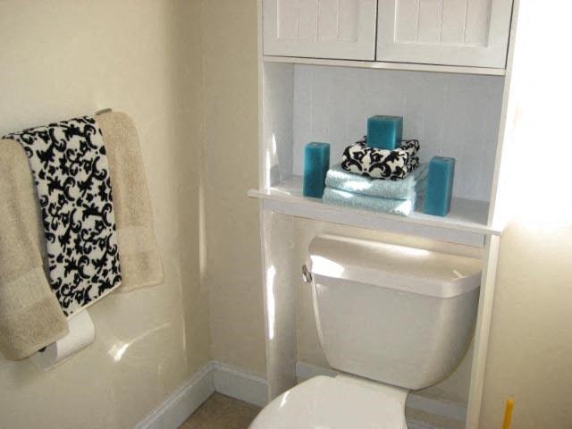 a bathroom with a toilet and some blue candles