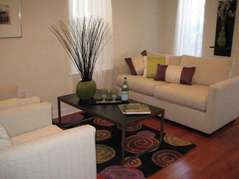 a living room with white couches and a coffee table