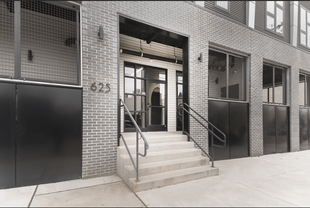 a black and white photo of the entrance to a brick building