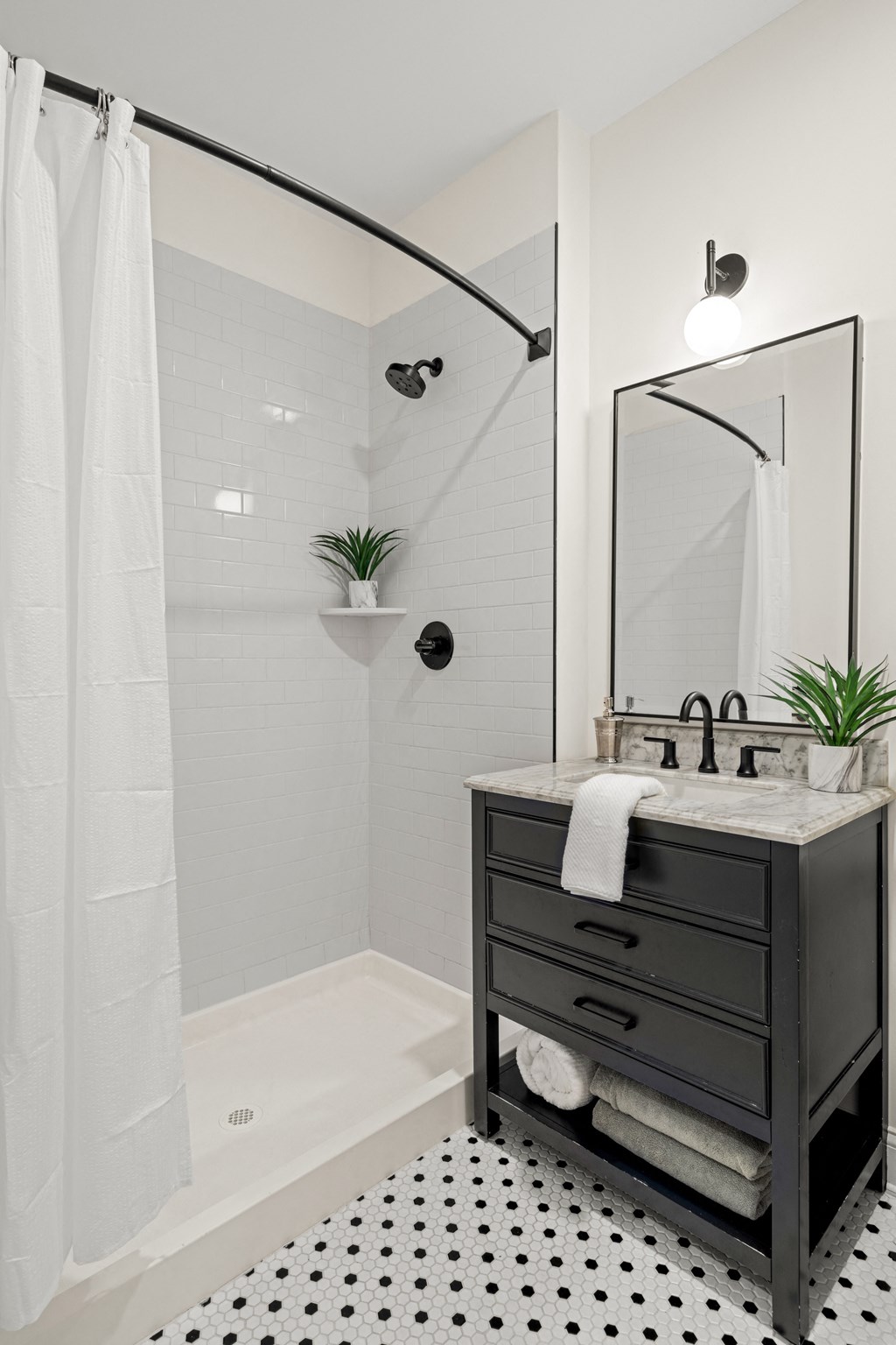 a bathroom with a shower and a sink and a mirror