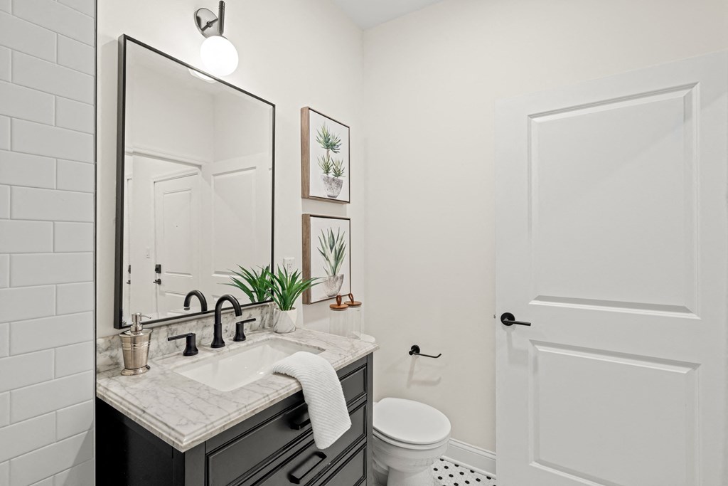 a bathroom with a sink and a mirror and a toilet