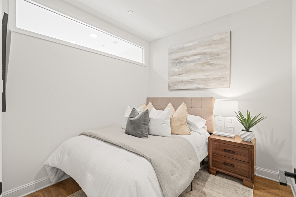 a bedroom with a large bed and a window