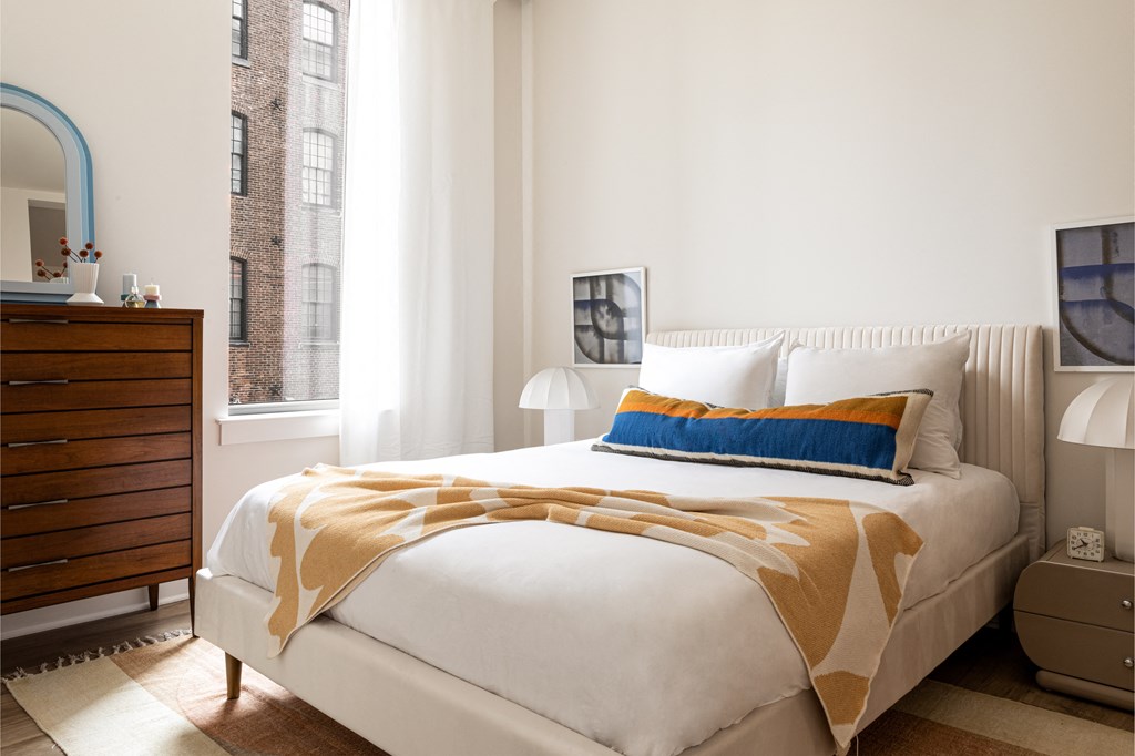 a bedroom with a bed and a dresser