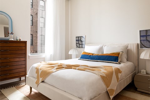 a bedroom with a bed and a dresser