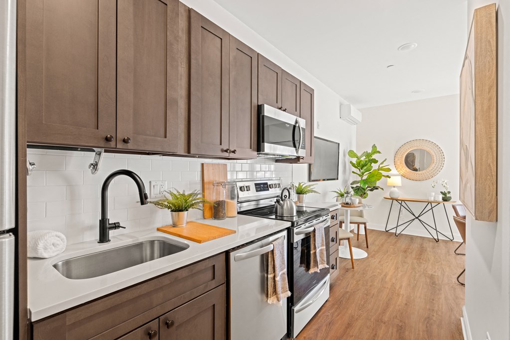 a kitchen with a sink and a stove and a microwave