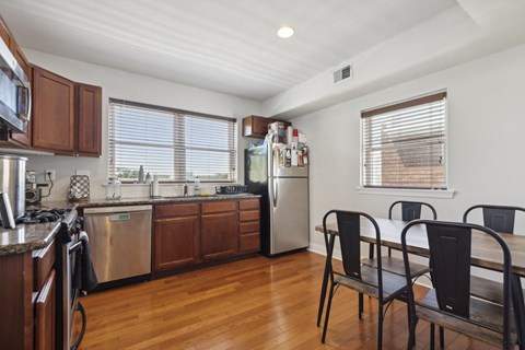 a kitchen and dining room with a table and chairs