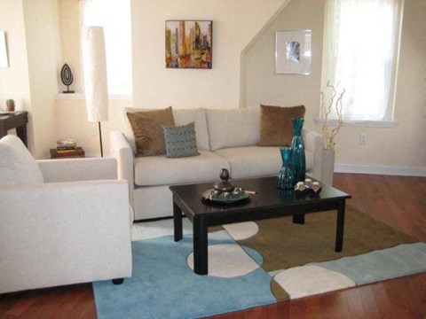 a living room filled with furniture and a coffee table