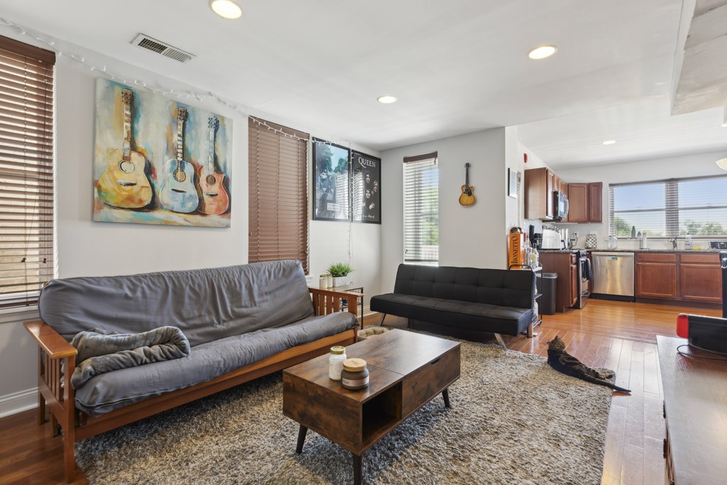 a living room with leather couches and a coffee table