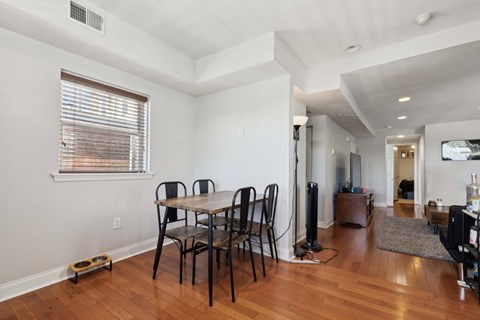 a dining room with a wooden table and chairs
