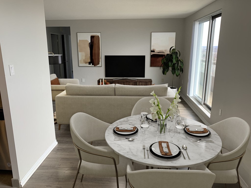 a living room and dining room with a table and chairs