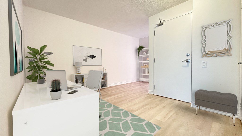 a living room with a white desk and a white door