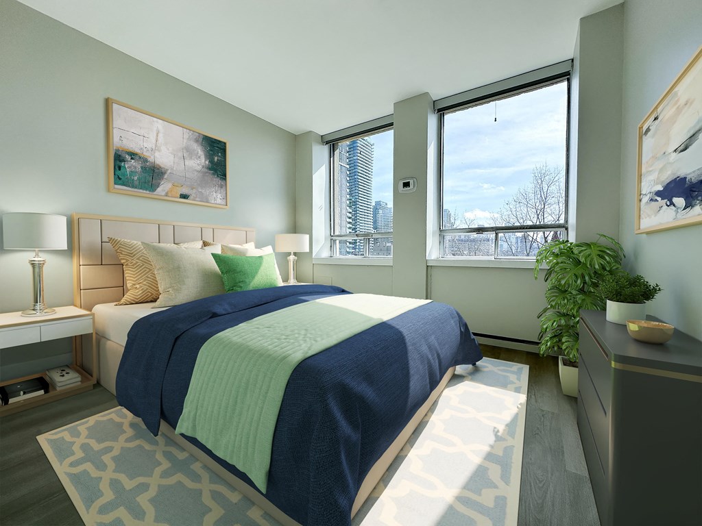 a guest bedroom with a console, two side tables, and a large window