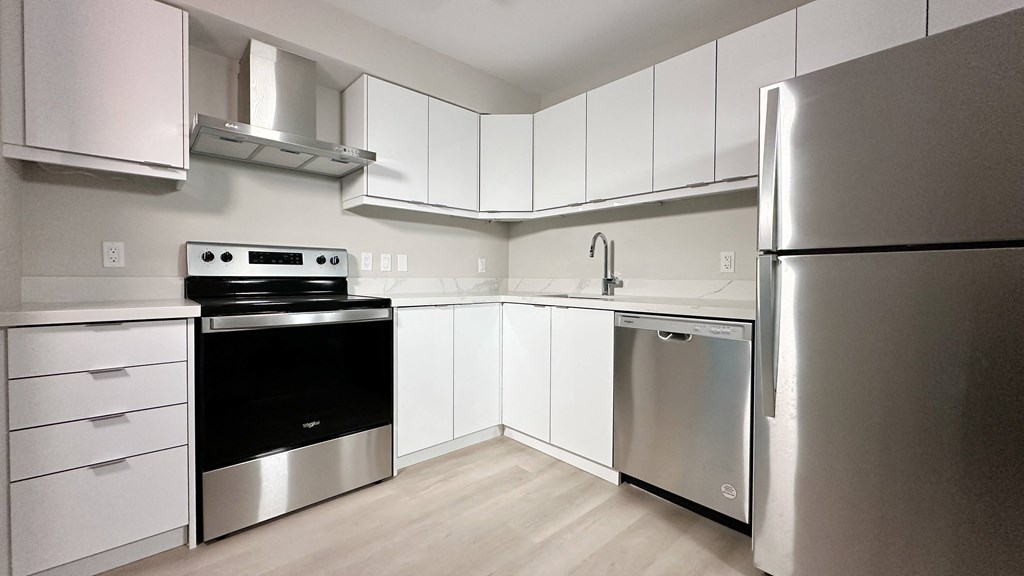 a kitchen with stainless steel appliances and white cabinets