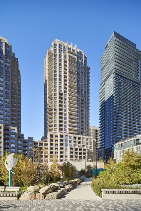 A cityscape with tall buildings and a clear blue sky.