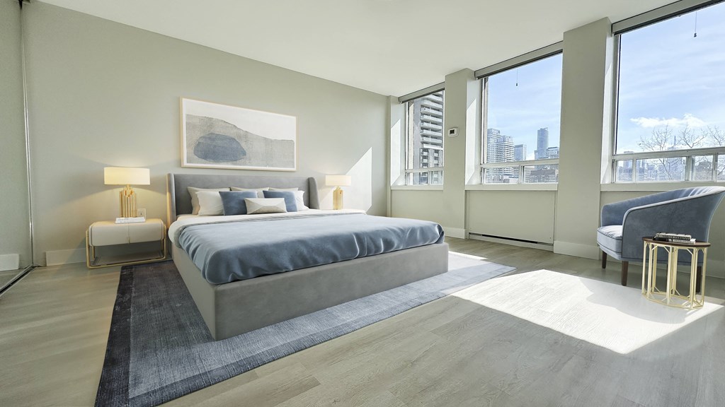 a bedroom with a large bed and a large window