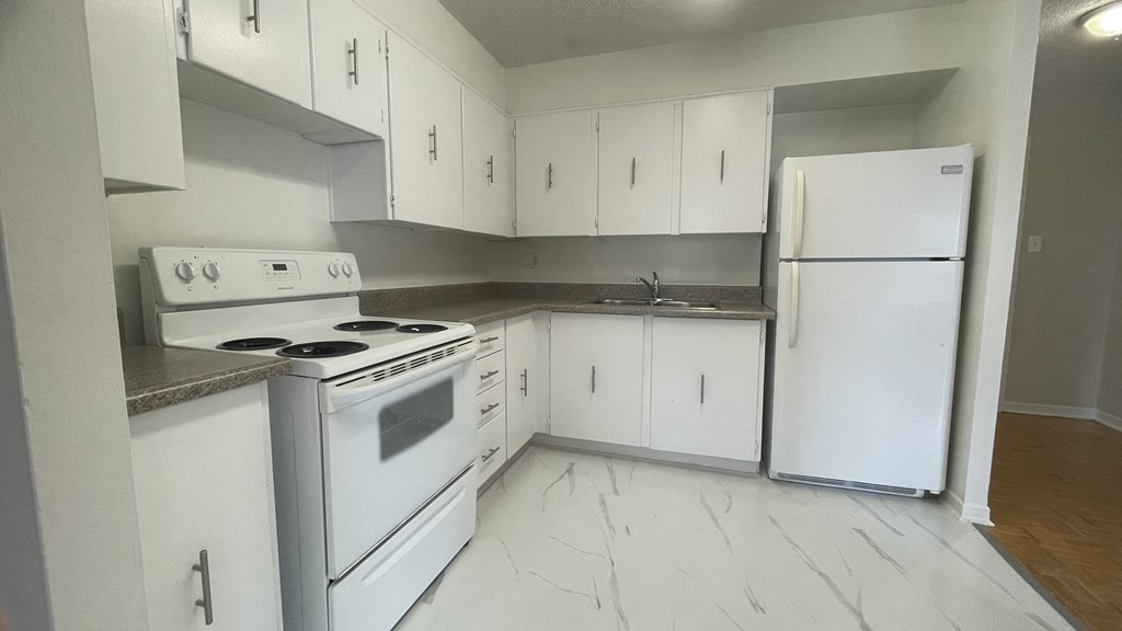 a kitchen with white appliances and white cabinets