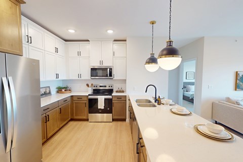 A modern kitchen with wooden cabinets and stainless steel appliances.