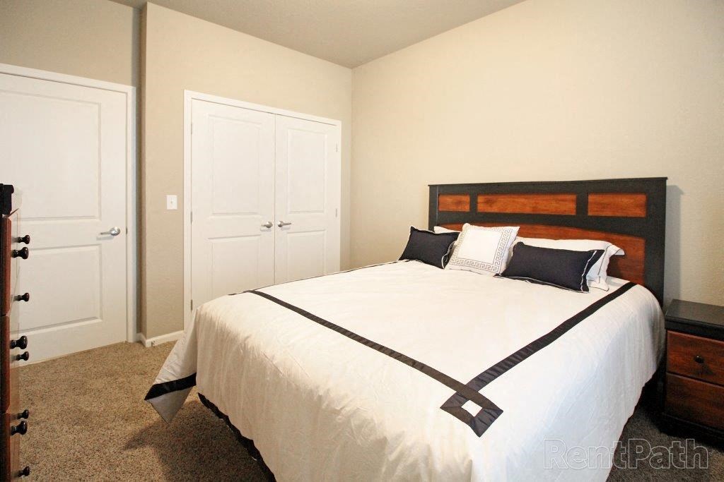 a bedroom with a bed and a closet