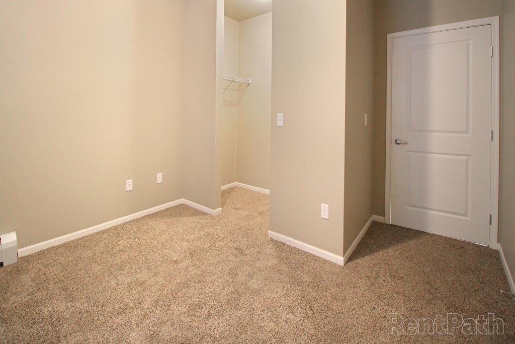 a room with a closet and a white door