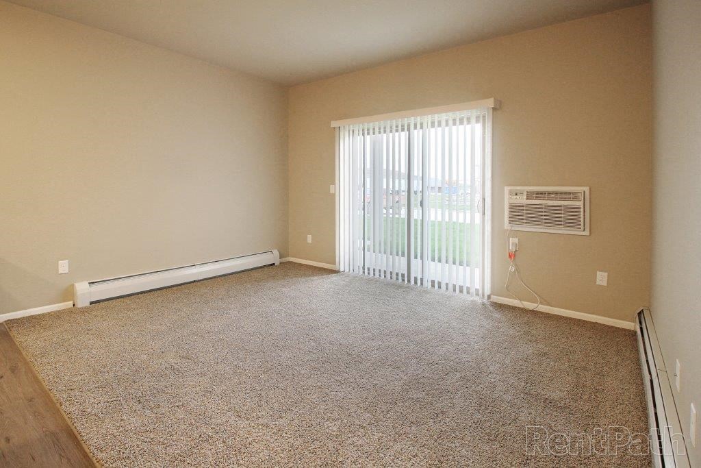 an empty living room with a sliding glass door
