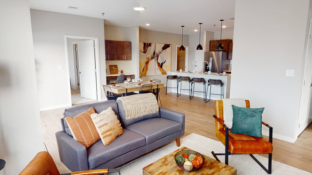 A living room with a grey couch and a wooden coffee table.