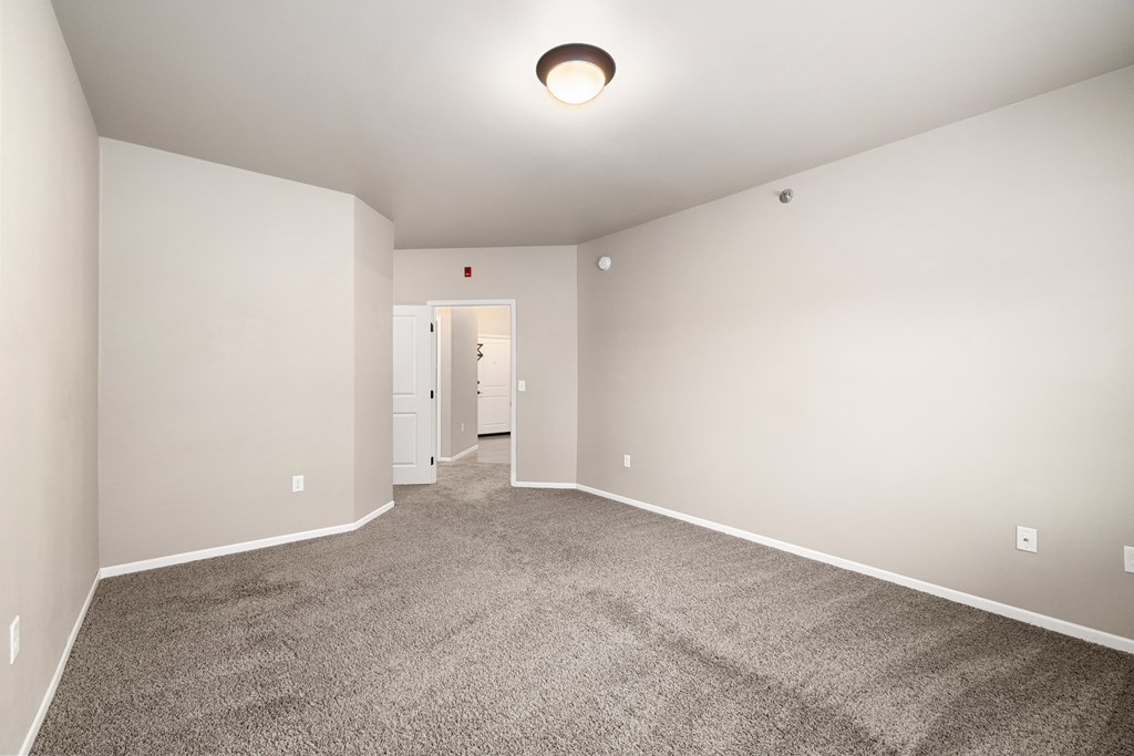 A room with carpeted floor and white walls.